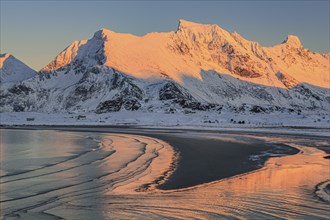 Snow-covered mountains in the evening light on the coast, beach, winter, Moskenesoya, Lofoten,