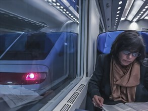 Woman Travel in a Train and Reading a Newspaper in Monte Carlo, Cote d azur, Monaco, Europe