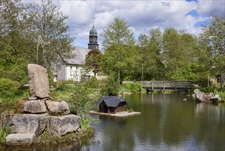 Spa gardens with pond and wooden bridge and St Johann's Church in the Innerlehen district, Bernau