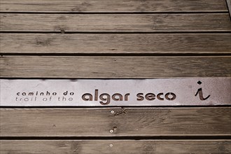 Lettering, logo on wooden boardwalk, wooden walkway, boardwalk, coastal hiking trail, Caminho de