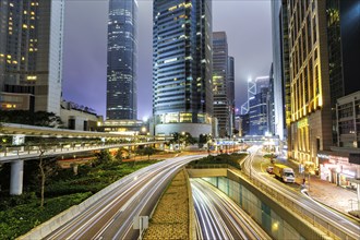 Traffic with streets and skyscrapers in the city of Hong Kong at night in Hong Kong, China, Asia