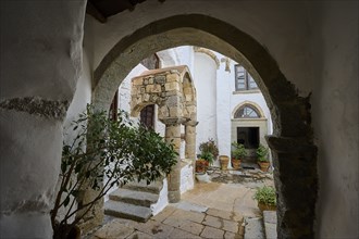 Historic courtyard of a monastery with stone arches and Mediterranean architecture, Inside the