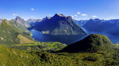 Panoramic aerial view of the inner Hjorundfjord above village Urke, Mt. Slogen in the back (left),