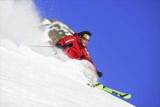 Skier in action, rapid descent on a slope, 30-40years, Alps, Austria, Europe