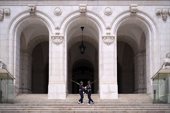 Armed guard on patrol in front of the parliament building Palacio de Sao Bento, Assembleia da