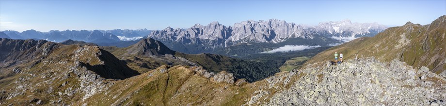 Two hikers, Alpine panorama, Carnic High Trail, view from the Carnic main ridge to the Sesto