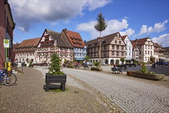 Old town with bus stop Gengenbach town hall, maypole, market square and half-timbered houses in