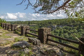 Stone and timber railing along the edge of a cliff at an overlook along the Little River Canyon Rim