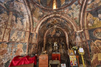 Interior of a church covered with frescoes and religious icons, several altars, Byzantine chapel