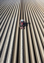 An aerial photo shows a tractor in a large asparagus field. Preparations for the asparagus season.