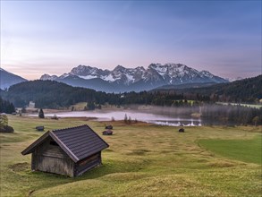 Huts at Geroldsee or Wagenbrüchsee, sunrise with morning mist, Krün near Mittenwald, Karwendel,