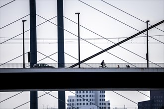 Oberkassler bridge over the Rhine near Düsseldorf, in front, behind the Rheinknie bridge, cyclist,