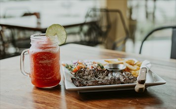 Delicious homemade steak with fries and strawberry lemonade. Nicaraguan skirt steak with fries and