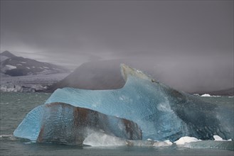 Glacier ice shimmering in various shades of blue near the edge of Negribreen, Stjorfjord,