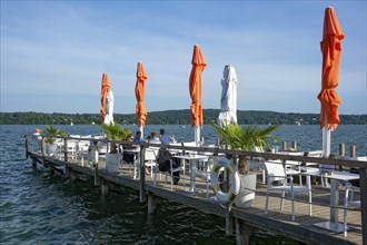 Old jetties with dining tables, lakeside restaurant, former Undosa wave pool, now H'ugo's Beach