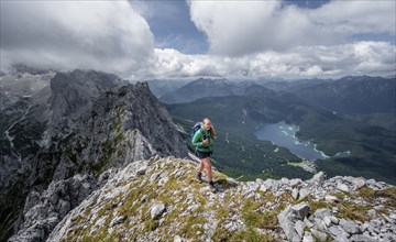 Mountaineer climbing Waxenstein, Eibsee lake and Wetterstein Mountains, Garmisch-Patenkirchen,