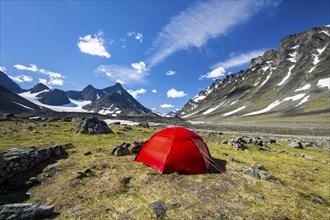 Red tent in Kaskasavagge valley, Kaskapakte glacier and mountains, mountain Kaskasatjakka and