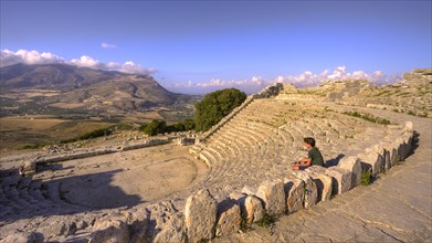 Evening light, Roman amphitheatre, sitting boy from the side, Segesta, Ancient site, Archaeological