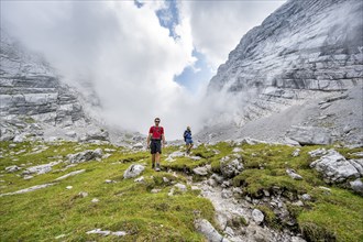 Two mountaineers on a hiking trail, cloudy mountain basin, descent via the Ofental valley, mountain