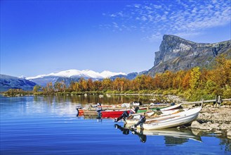 Motorboats at a jetty in a mountain lake at Sarek National Park in Lapland in the north of Sweden,