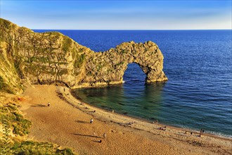 Coastline with bathing beach at Durdle Door, limestone rock bridge, UNESCO World Heritage Site,