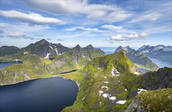 Mountain landscape with steep rocky peaks fjords and sea, view from the top of Munken to lakes