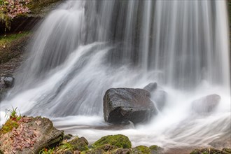 Beautiful fresh mountain waterfall in a wild and remote valley in winter. Vosges, Bas-Rhin,