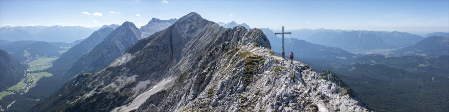 Alpine panorama, hikers at the summit cross, Westliche Wettersteinspitze, Bavaria, Germany, Europe