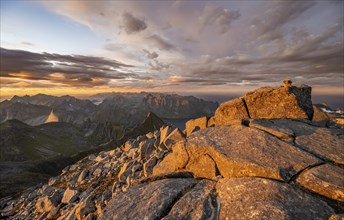 View over mountain top and sea, dramatic sunset, at the top of Hermannsdalstinden, Moskenesöy,