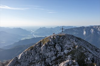 Two hikers at the summit, aerial view, evening mood in the mountains, summit cross of the