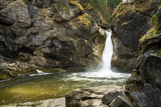 The lower part of the Buchenegg waterfalls, surrounded by rocks. Autumn. Oberstaufen, Upper