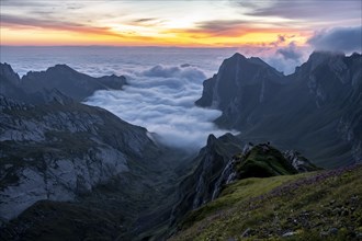 View over SÃ¤ntis mountains into the valley of Meglisalp at sunrise, high fog in the valley,