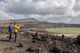 Tourists at the Janubio salt flats, Salinas de Janubio, sea salt production, Lanzarote, Canary