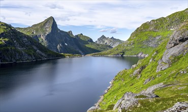 Lake Tennesvatnet and mountain landscape with rocky pointed peaks, Hermannsdalstinden mountain in