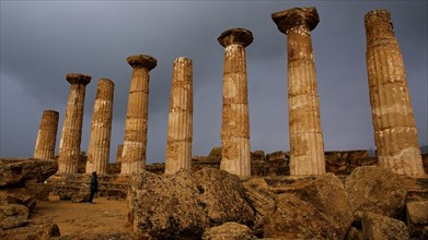 Row of columns, chapter, Heracles temple, dark clouds, sun, thunderstorm atmosphere. Valley of the