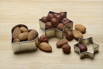 Nuts and cookie cutters, almonds and hazelnuts