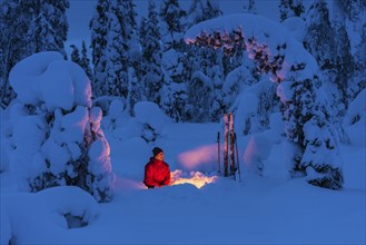 Man at the campfire, Muddus National Park, World Heritage Laponia, Norrbotten, Lapland, Sweden,