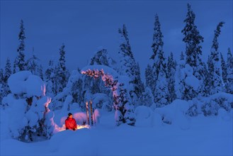 Man at the campfire, Muddus National Park, World Heritage Laponia, Norrbotten, Lapland, Sweden,