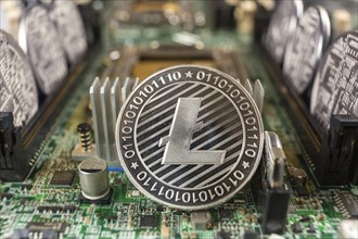 Litecoin close-up on a computer circuit motherboard as a blockchain technology payment network.