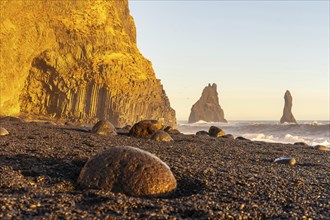 Beautiful on the black sand beach of Reynisfjara at sunset in Iceland