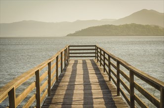 Beautiful wooden dock in pond overlooking mountains, quiet view