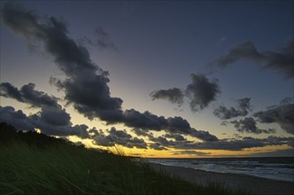 Sunset on the baltic coast with clouds in the sky. in addition, the sound of the sea and a fresh