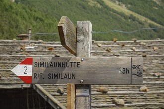 Wooden signpost in a mountainous landscape leading to the Similaunhütte, Alps, Austria, Europe