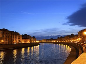 Pisa, Italy. September 16, 2023.The Ponte di Mezzo in the evening and the banks of the Arno River.