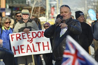 CHRISTCHURCH, NEW ZEALAND, JULY 24, 2021, A man speaks at a protest rally at the Bridge of