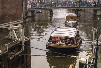 Amsterdam, Netherlands. October 2022. The old locks and canal boats at the St. Olofsteeg in