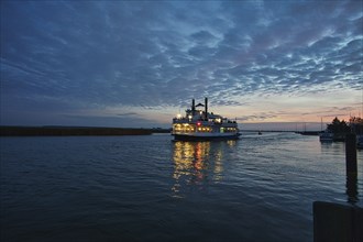 From the harbor in zingst the bodden view with burning sky with steamer, dynamic clouds in full