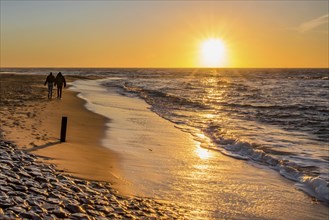 Den Helder, Netherlands. January 2022. Setting sun on the beach of Den Helder, Netherlands.