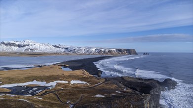 Aerial drone view of the beautiful Dyrholaey beach in Iceland in the cold winter