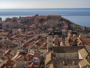 Panoramic view of a historic old town with brick roofs and the sea in the background, Dubrovnik,